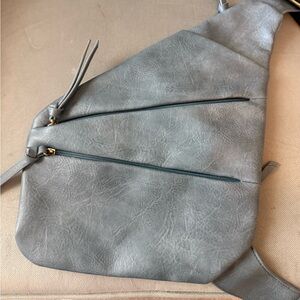 Silver cross body purse. Side pockets are deep strap is 
Adjustable